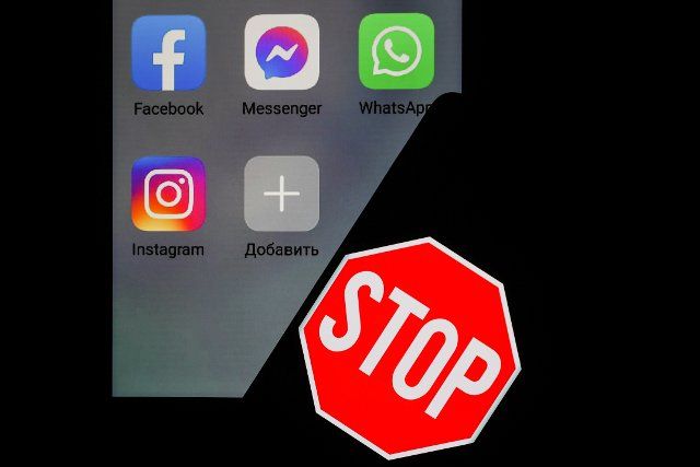 NOVOSIBIRSK, RUSSIA â MARCH 11, 2022: Pictured in this photo illustration are logos of Instagram, Facebook, Messenger, and WhatsApp apps and a stop sign on a smartphone. The Russian Federal Service for Supervision of Communications, Information 