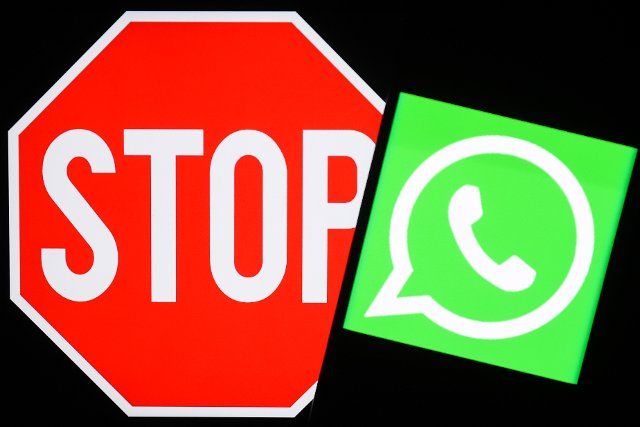 NOVOSIBIRSK, RUSSIA â MARCH 11, 2022: Pictured in this photo illustration is the logo of the WhatsApp messaging service and a stop sign. The Russian Federal Service for Supervision of Communications, Information Technology and Mass Media 