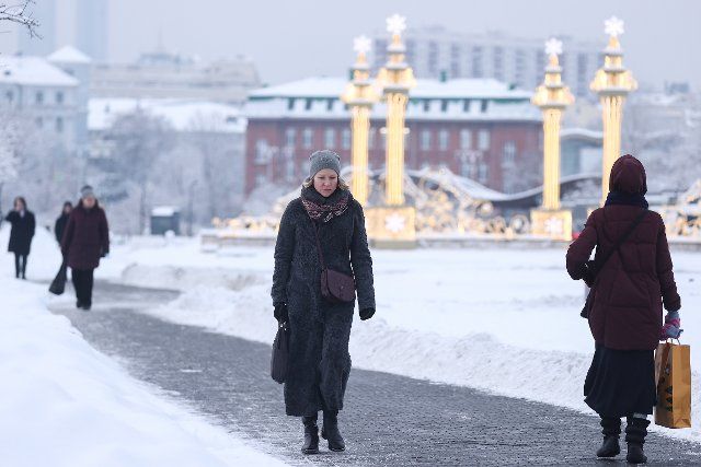 MOSCOW, RUSSIA - DECEMBER 14, 2021: People walk past Moscow\