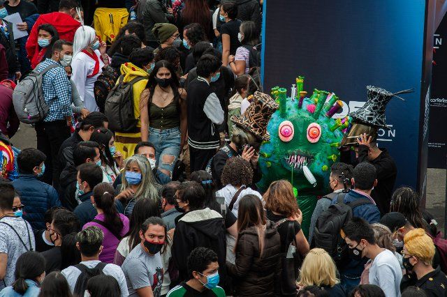 An attendee using a costume of the SarsCov2 virus (COVID-19) virus, roams around more than a thousand people at the Corferias Fair Compund amidst COVID-19 social distancing restrictions during the fourth day of the SOFA (Salon del Ocio y la Fantasia