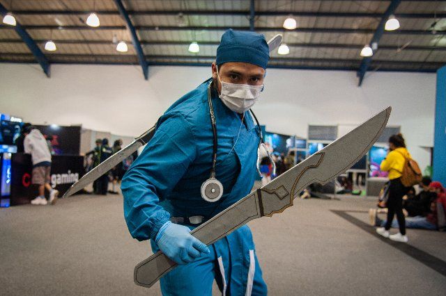 An attendee cosplays a doctor as an aim to showcase how medics are heroes too during the fourth day of the SOFA (Salon del Ocio y la Fantasia) 2021, a fair in Colombia that mixes Cosplay, gaming, superhero and movie fans from across Colombia, in 