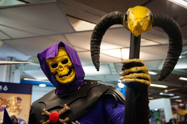 A fan of He-Man poses for a photo using a costume of Skeletor during the fourth day of the SOFA (Salon del Ocio y la Fantasia) 2021, a fair aimed to the geek audience in Colombia that mixes Cosplay, gaming, superhero and movie fans from across 