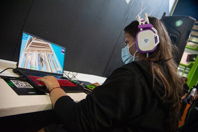 An attendee plays during an Epic Games - Fortnite tournament during the fourth day of the SOFA (Salon del Ocio y la Fantasia) 2021, a fair aimed to the geek audience in Colombia that mixes Cosplay, gaming, superhero and movie fans from across 