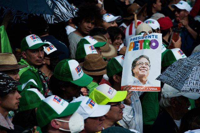 Supporters of Gustavo Petro hold a campaign banner of the candidate during the closing campaign rally of left-wing presidential candidate for the political alliance \