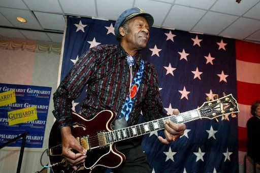 Rock and Roll legend Chuck Berry plays the guitar and struts across the stage as he warms up the crowd before democratic presidential candidate Dick Gephardt appears for a fund raiser at the Renaissance Savery Hotel in Des Moines Iowa on January 18...
