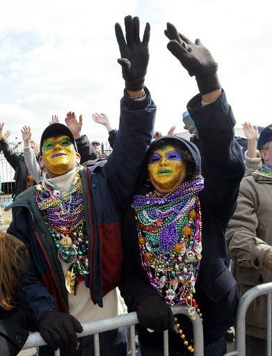 Parade goers beg for beads during the St. Louis Mardi Gras Parade in St. Louis on February 21 2004. The parade second lartgest only to New Orleans has been entertaining St. Louisians for over 20 years.  (UPI Photo\/Bill Greenblatt)