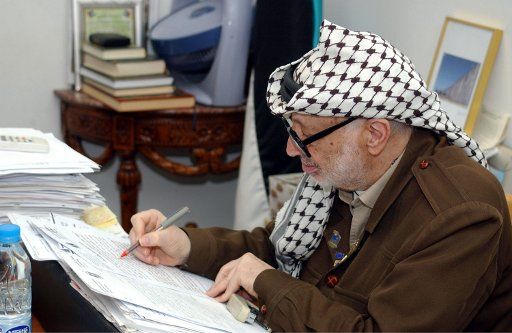 Palestinian leader Yasser Arafat works in his office on March 13 2004 in Ramallah West Bank. .  (UPI Photo\/Hussein Hussein\/Palestinian Authority)
