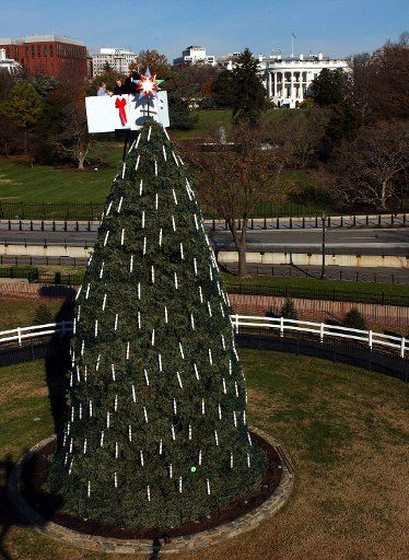 The last ornament is placed on the National Christmas Tree on the Ellipse in front of the White House in Washington on November 25 2003.    (UPI Photo\/Roger L. Wollenberg)