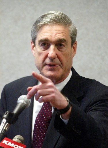 FBI Director Robert S. Mueller III answers a reporters question during a visit to the St. Louis FBI Office in St. Louis on December 17 2003. Mueller is in St. Louis to thanks local law enforcement officals and St. Louis FBI Office workers for their...