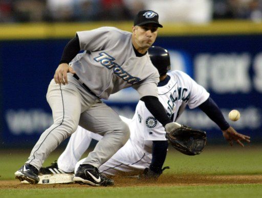 Toronto Blue Jay second baseman Frank Menechino waits for the throw as Seattle Mariner Hiram Bocachica slides safely in the fifth inning at Safeco Field on Wednesday June 6 2004 in Seattle WA. (UPI Photo\/Jim Bryant)