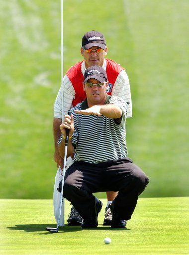 Rich Beem of El Paso TX discusses his shot with his caddy Bill Heam before hitting in his put shot at the 17th hole at the PGA Booz Allen Classic on June 24 2004 in Potomac Maryland.  Beem is leading the field on this first day of play.  (UPI...