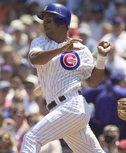 Chicago Cubs outfielder Moises Alou hits a single against the Houston Astros in the first inning that drove in outfielder Corey Patterson at Wrigley Field in Chicago Illinois on Thursday July 1 2004.  (UPI Photo\/Tannen Maury)