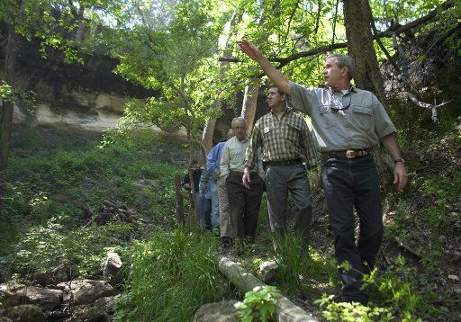 President George W. Bush leads a tour of Prairie Chapel Ranch with wildlife conversation leaders and sportsmen leaders Thursday April 8 2004. Pictured with the President from left are Jeffrey Crane Director of Policy and Programs Congressional...