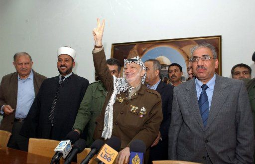 Palestinian leader Yasser Arafat hosts a mass march in his support at his offices in Ramallah West Bank on April 25 2004. (UPI Photo\/Hussein Hussein) 