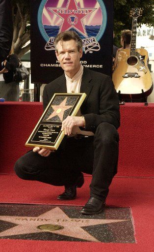 Grammy-winning entertainer and actor Randy Travis poses for photographers after he was honored with the 2264th star on the Hollywood Walk of Fame during an unveiling ceremony in Los Angeles California September 29 2004.    (UPI Photo\/Jim Ruymen)