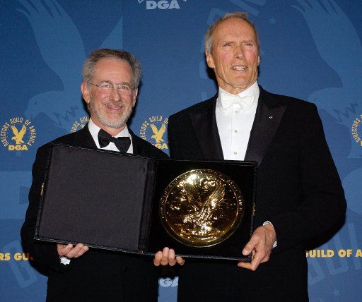 Actor and director Clint Eastwood (news) right holds his award for outstanding directorial achievement in feature film for his work in "Million Dollar Baby" with Steven Spielberg who presented the award to Eastwood at the 57th Annual Directors...