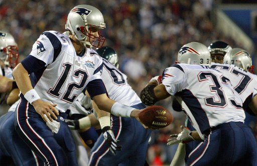 Tom Brady of the New England Patriots hands off to Kevin Faulk in the first half of Superbowl XXXIX in Jacksonville Florida on February 6 2005. (UPI Photo\/John Angelillo)