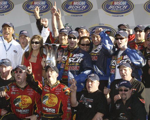 Martin Truex Jr celebrates winning the  NASCAR Busch  Series Championship with owners Teresa Earnhardt and Dale Earnhardt Jr at Homestead Miami-Dade Speedway  in Homestead  Florida on November 20 2004.  (UPI Photo\/Michael Bush)