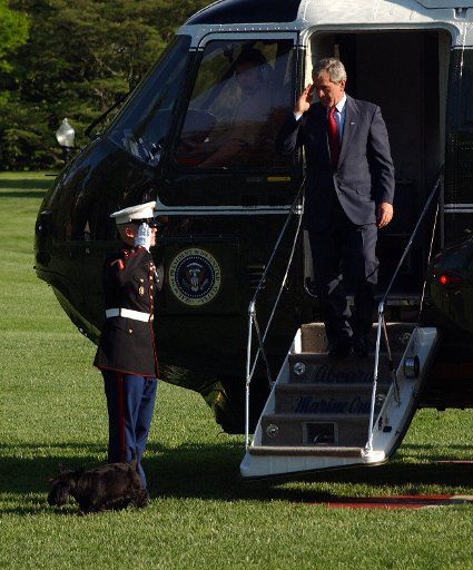 U.S. President George W. Bush disembarks Marine One with his dog Barney on the South Lawn of the White House on April 26 2005. Bush was in Galveston Texas discussing Social Security reform.   (UPI Photo\/Roger L. Wollenberg)