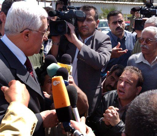 Palestinian President Mahmoud Abbas speaks with a man during the "March of Palestinian Injured and Handicapped"  in Gaza on April 26 2005.   (UPI Photo\/Abd Alhalim Mosa\/Palestinian Authority)                             