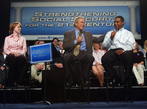 U.S. President George W. Bush discusses Social Security reform with Yuctan Hodge (r) Colleen Rummel (l) and other guests at James Lee Community Center in Falls Church Va on April 29 2005.   (UPI Photo\/Roger L. Wollenberg)