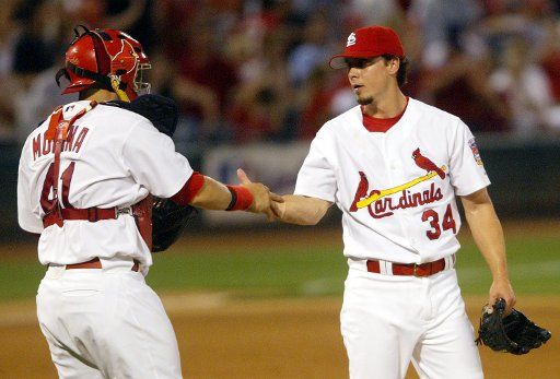 St. Louis Cardinals relief pitcher Randy Flores (R) is congratulated by catcher Yadier Molina after pitching the ninth inning defeating the New York Yankees 8-1 at Busch Stadium in St. Louis on June 10 2005.  (UPI Photo\/Bill Greenblatt
