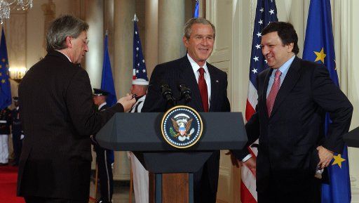 U.S. President George W. Bush talks with European Commission President Jose Manuel Barroso right and European Union President Jean-Claude Juncker left after a media availability in the East Room of the White House on June 20 2005 in Washington....