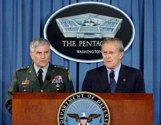 US Army Gen. George Casey left commander of Multinational Force Iraq and US Defense Secretary Donald Rumsfeld speak to the media about the current situation in Iraq during a news briefing at the Pentagon in Arlington Va. on June 27 2005.   (UPI...