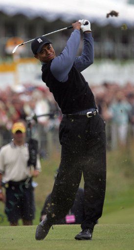 American golfer Tiger Woods plays a fairway shot  on the first day at the 2005 British Open golf championship on the old course of St. Andrews in Scotland on July 14 2005.   (UPI Photo\/Hugo Philpott)