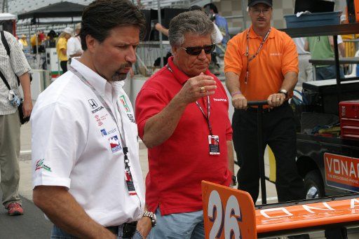 Michael Andretti and Father Mario Andretti look over the car that Michael\