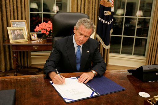 President George W. Bush signs legislationÊÊinÊthe Oval Office Friday Sept. 2 2005Ê Êto provide 10.5 billion dollars in relief aid for the areasÊÊalong the Gulf CoastÊaffected by Hurricane Katrina. Congress approved the bill late Thursday.   (UPI...