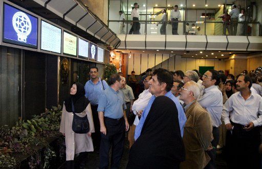 Some of the shareholders look at the televisions that show the Exchange indicators at the Tehran Stock Exchange Market in Tehran Iran on September 4 2005. Dealing in the bourse has changed since the election of the new president  Mahmoud...