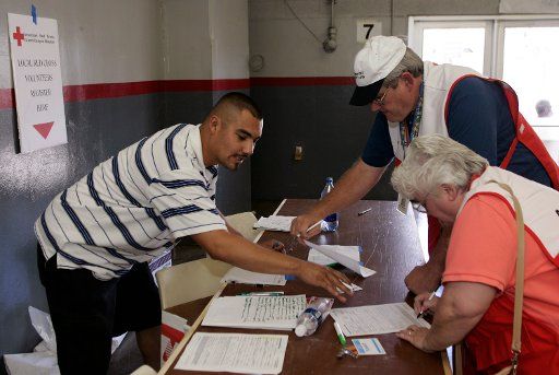 Volunteer Romi Hernadez of Phoenix sign in volunteers Russ and Bonnie Sargent at Veterans Coliseum where victims of hurricane Katrina are being cared for in Phoenix Arizona September 5 2005.     (UPI Photo\/Will Powers)