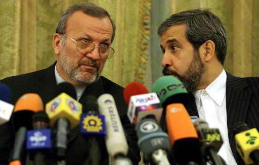 Iran Foreign Minister Manouchehr Mottaki (L) and the foreign minister\