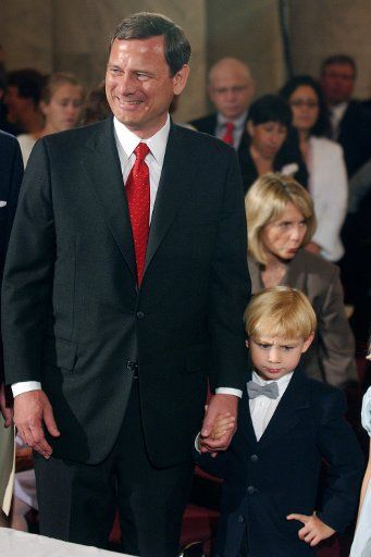 Supreme Court Justice nominee John Roberts and his son Jack wait for opening statements to begin in his Judicial Committee confirmation hearing on Capitol Hill in Washington on September 12 2005. (UPI Photo\/Kevin Dietsch)
