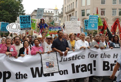 Anti-war demonstrators march in downtown Washington led by Cindy Sheehan and Rev. Jesse Jackson (C) on September 24 2005.  Tens of thousands of diverse demonstrators protested the Iraq War.   (UPI Photo\/Pat Benic)