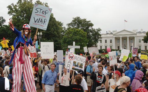 Uncle Sam on stilts and a Pinocchio nose walks in a massive anti-war protest march past the White House in downtown Washington on September 24 2005.  Tens of thousands of diverse demonstrators protested the Iraq War.   (UPI Photo\/Pat Benic)