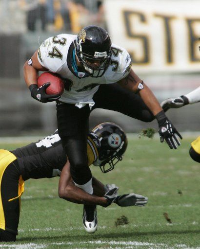 Jacksonville Jaguars Alvin Pearman is brought down by Pittsburgh Steelers Ike Tayor during the second quarter at Heinz Field in Pittsburgh Pennsylvania on October 16 2005. The Jaguars went on to defeat the Steelers in overtime 23 to 17....