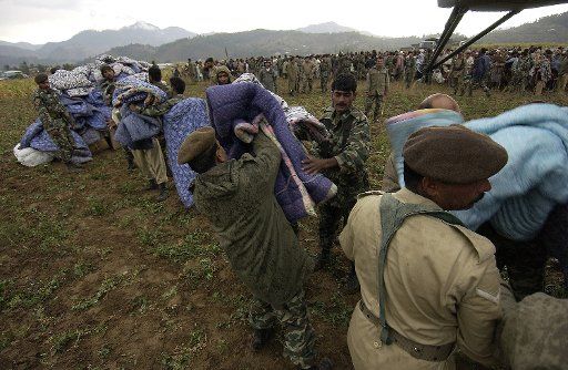 Pakistani soldiers unload disaster relief supplies from a U.S. Navy MH-53E "Sea Dragon" helicopter in Balakot Pakistan on October 15  2005.   (UPI Photo\/Mike Buytas\/USAF) 