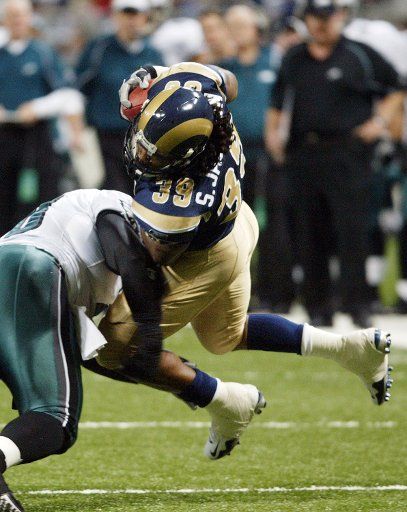 St. Louis Rams Steven Jackson (39) is upended by Philadelphia Eagles Hollis Thomas during a running play in the second quarter at the Edward Jones Dome in St. Louis on December 18 2005. Jackson gained 82-yards as the Rams lost 17-16. (UPI Photo\/Bill...