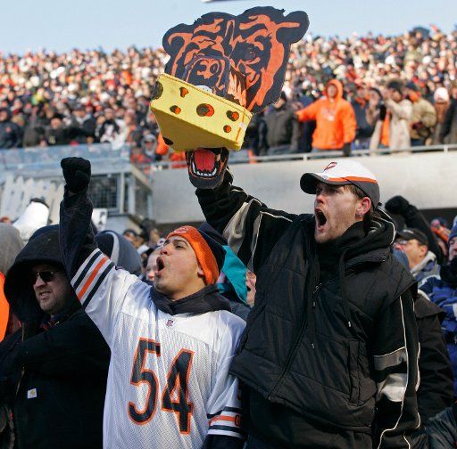 Chicago Bears fans Eddie Santillanes left and Kevin Allison cheer on their team as they play the Green Bay Packers during the fourth quarter on December 4 2005 at Soldier Field in Chicago. The Bears won 19-7. (UPI Photo\/Brian Kersey)