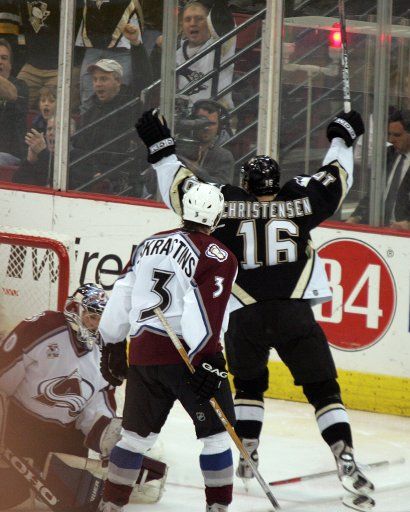 Pittsburgh Penguins C Erik Christensen (16) skates pass Colorado Avalanche goalie Vitaly Kolesnik with his stick held high after scoring in the second period on December 8 2005 at Mellon Arena in Pittsburgh Pennsylvania.     (UPI Photo\/Stephen Gross)