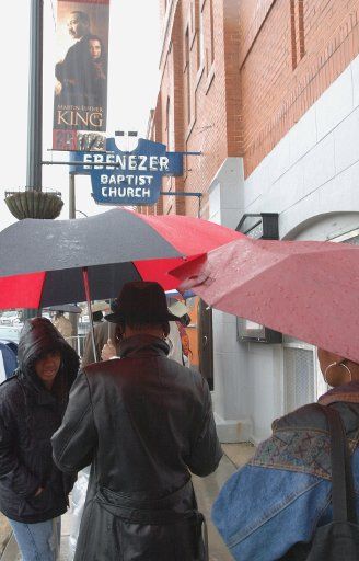 Mourners stand in a steady rain waiting to pay their respects to Coretta Scott King as she lies in state in the historic Ebenezer Church on Auburn Ave. in Atlanta Ga. February 6 2006. (UPI Photo\/John Dickerson)