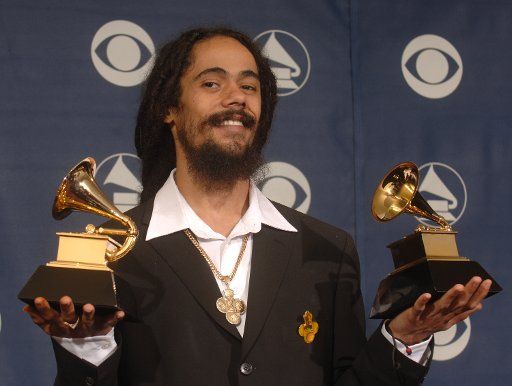 Damian Marley holds his two Grammys for Best Reggae Album and Best Urban\/Alternative Performance at the 48th Annual Grammy Awards at the Staples Center in Los Angeles on February 8 2005.  (UPI Photo\/Phil McCarten)   