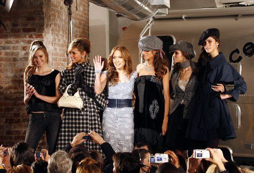 Jennifer Lopez collects her models after a viewing of her Sweetface collection during Olympus Fashion Week in New York City on February 10 2006.    (UPI Photo\/John Angelillo)    