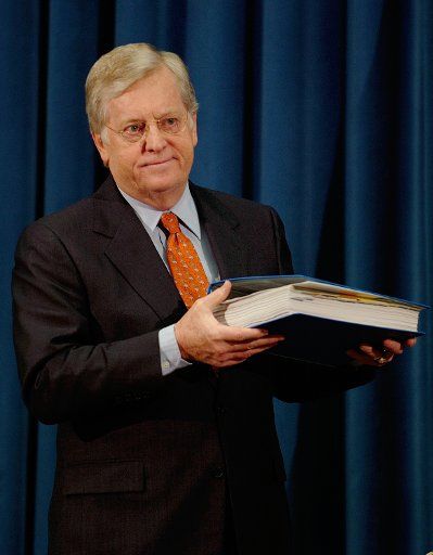 U.S. Ambassador to Japan J. Thomas Schieffer shows the report of the investigation conducted by the U.S.Department of Agriculture on the ineligible shipment of meat products to Japan during a press conference in Tokyo Japan on Feb. 17 2006. (UPI...
