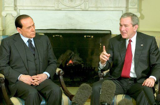 United States President George W. Bush meets Prime Minister Silvio Berlusconi (L) of Italy in the Oval Office of the White House on February 28 2006.  (UPI Photo\/Ron Sachs\/POOL)