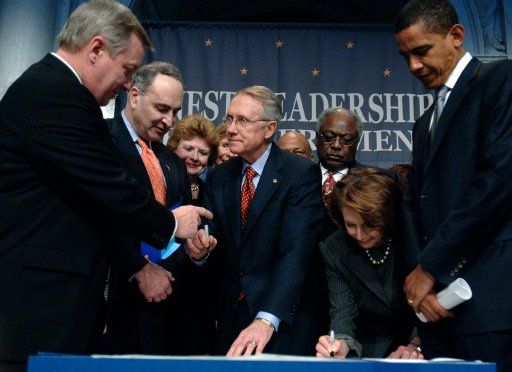 Senate Minority Leaders Sen. Harry redi (D-NV) passes the pen to Sen. Richard Durbin (D-IL) while Sen. Nancy Pelosi (D-CA) signs the Democratic Declaration: Honesty Leadership and Open Government while other democratic constituents watch on at a news...