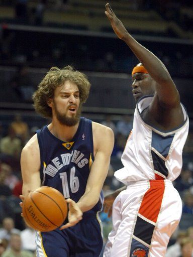 Memphis Grizzlies forward Pau Gasol of Spain looks to pass around Charlotte Bobcats forward Jumaine Jones at the Charlotte Bobcats Arena in Charlotte N.C. on April 12 2006. (UPI Photo\/Nell Redmond)