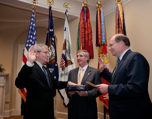 New Chief of Staff Josh Bolten (L) is joined by out going Chief of Staff Andrew Card (C) as Bolten is sworn-in by Deputy Chief of Staff Joe Hagin on April 14 2006 in the Roosevelt Room of the White House.   (UPI Photo\/ Paul Morse\/White House)